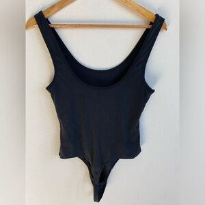 Dress Forum women’s black ribbed bodysuit